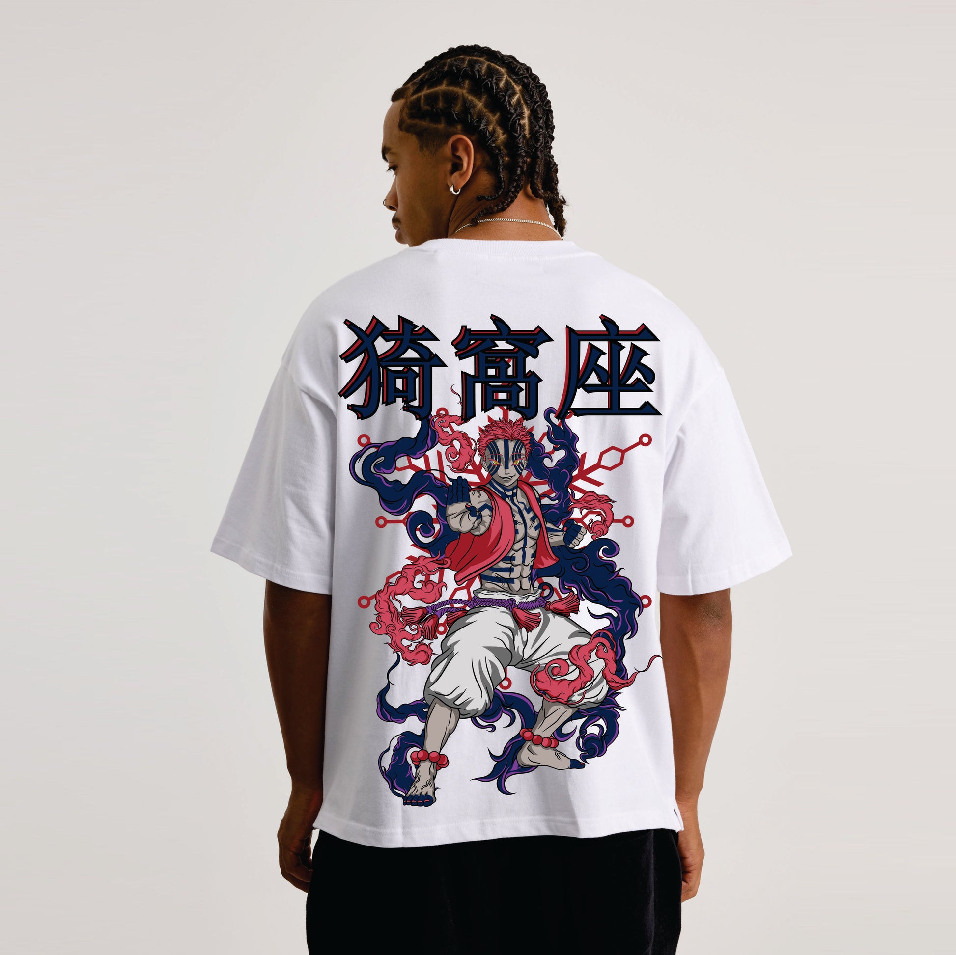 Person wearing a white t-shirt with a colorful graphic design on the back against a plain background