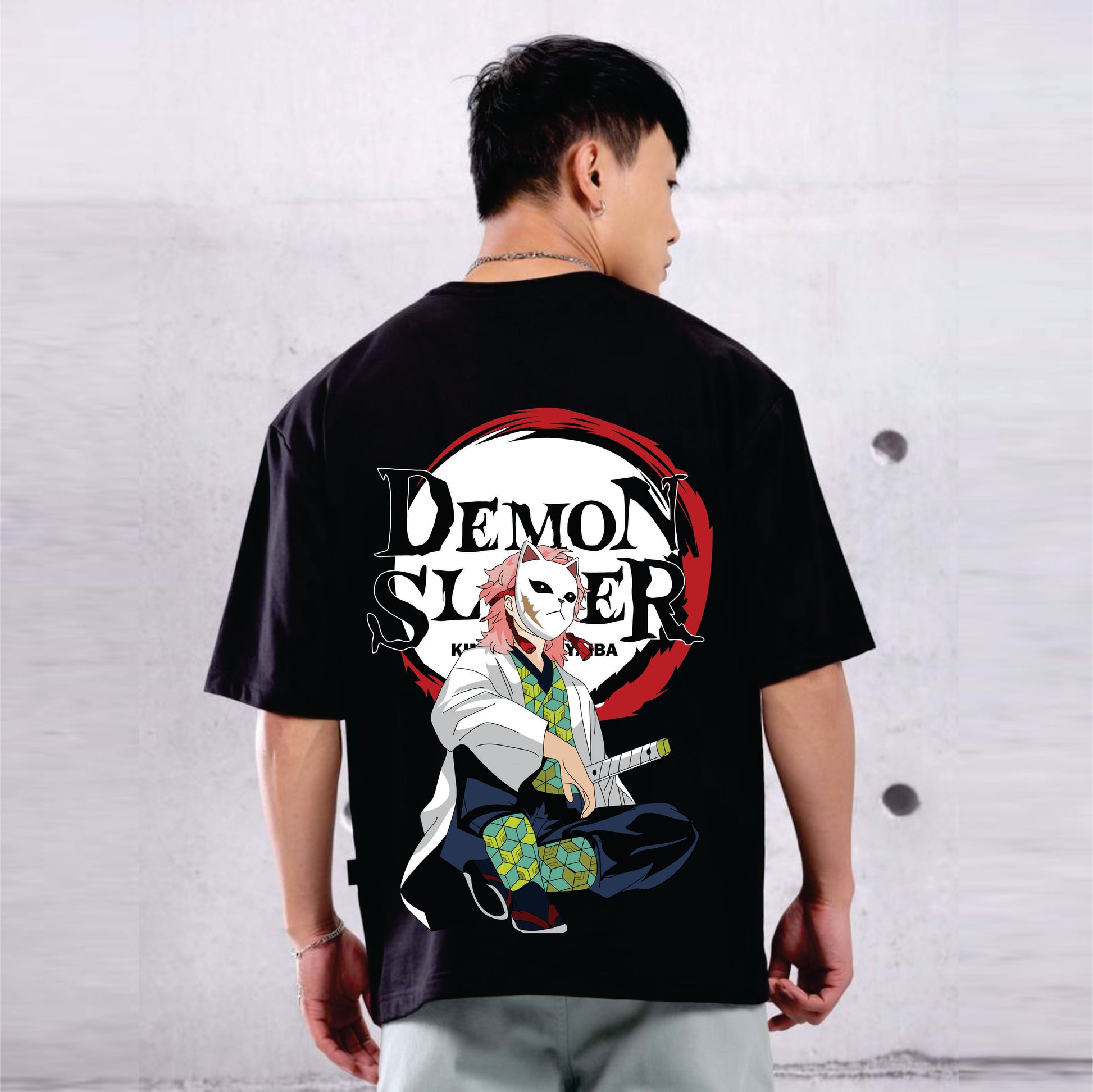 Person wearing a black t-shirt with 'Demon Slayer' graphic design on the back.