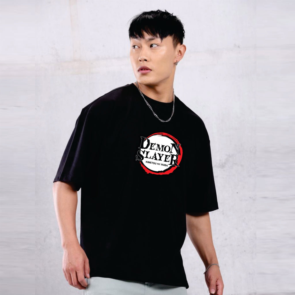 Person wearing a black t-shirt with 'Demon Slayer' logo against a plain background