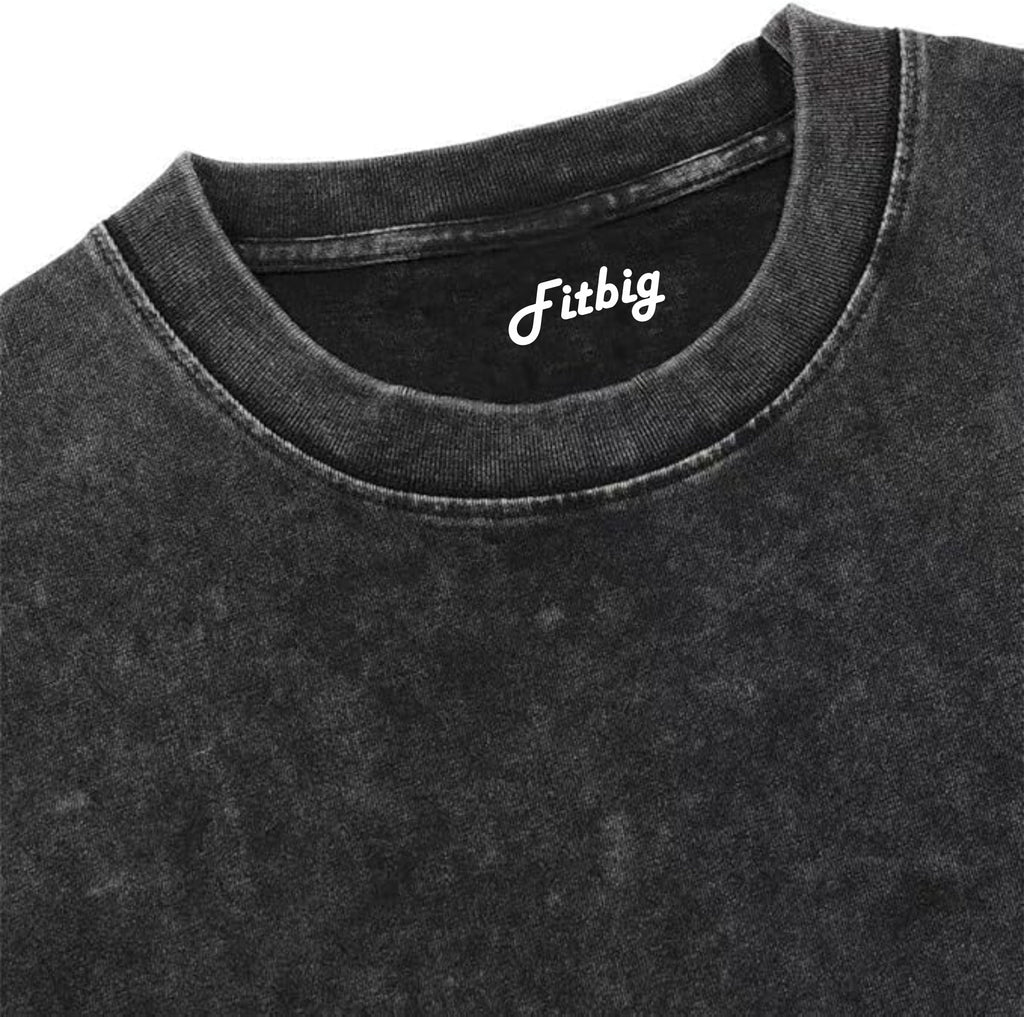 Close-up of a black shirt with 'Fitbig' logo on a white background