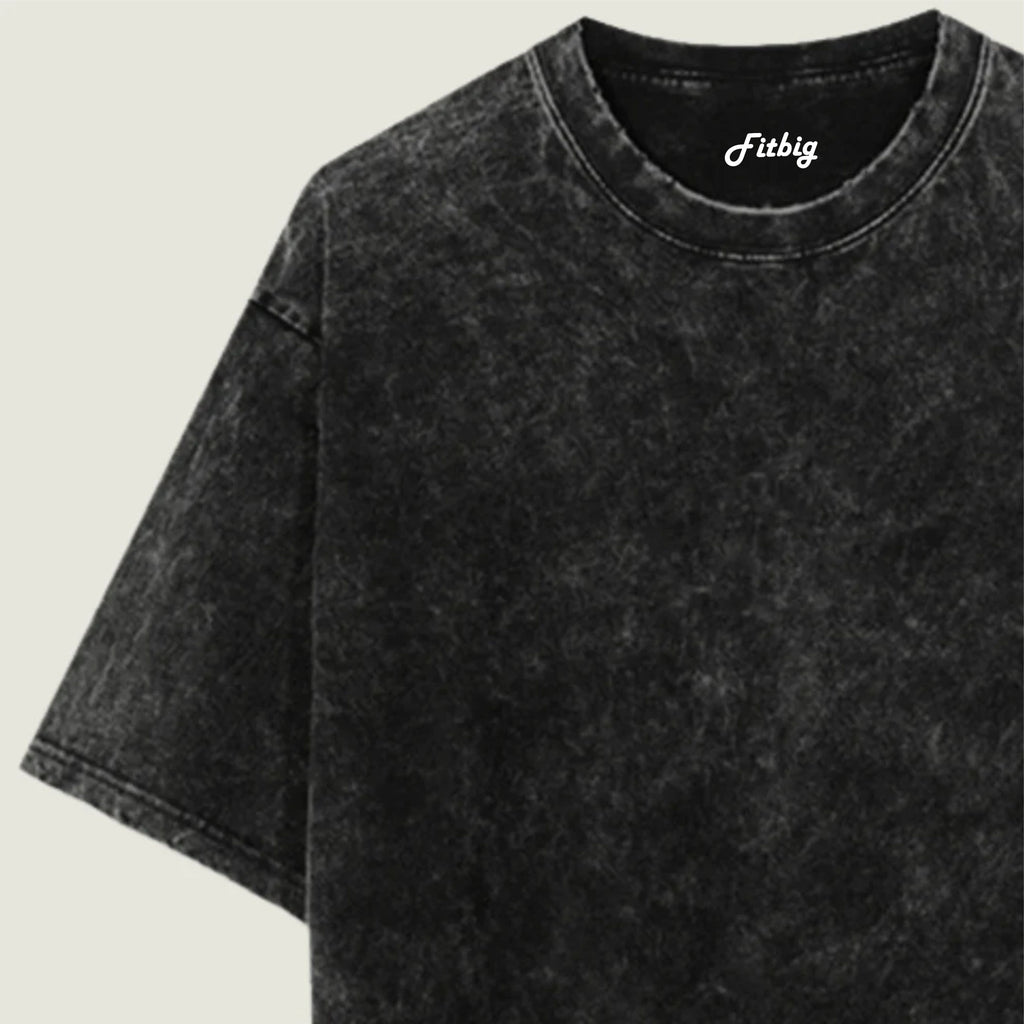 Black acid-wash t-shirt with 'Fitbig' logo on a beige background