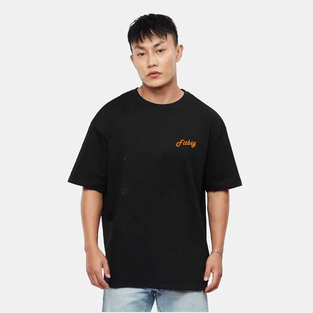 Person wearing a black t-shirt with a yellow logo on a white background