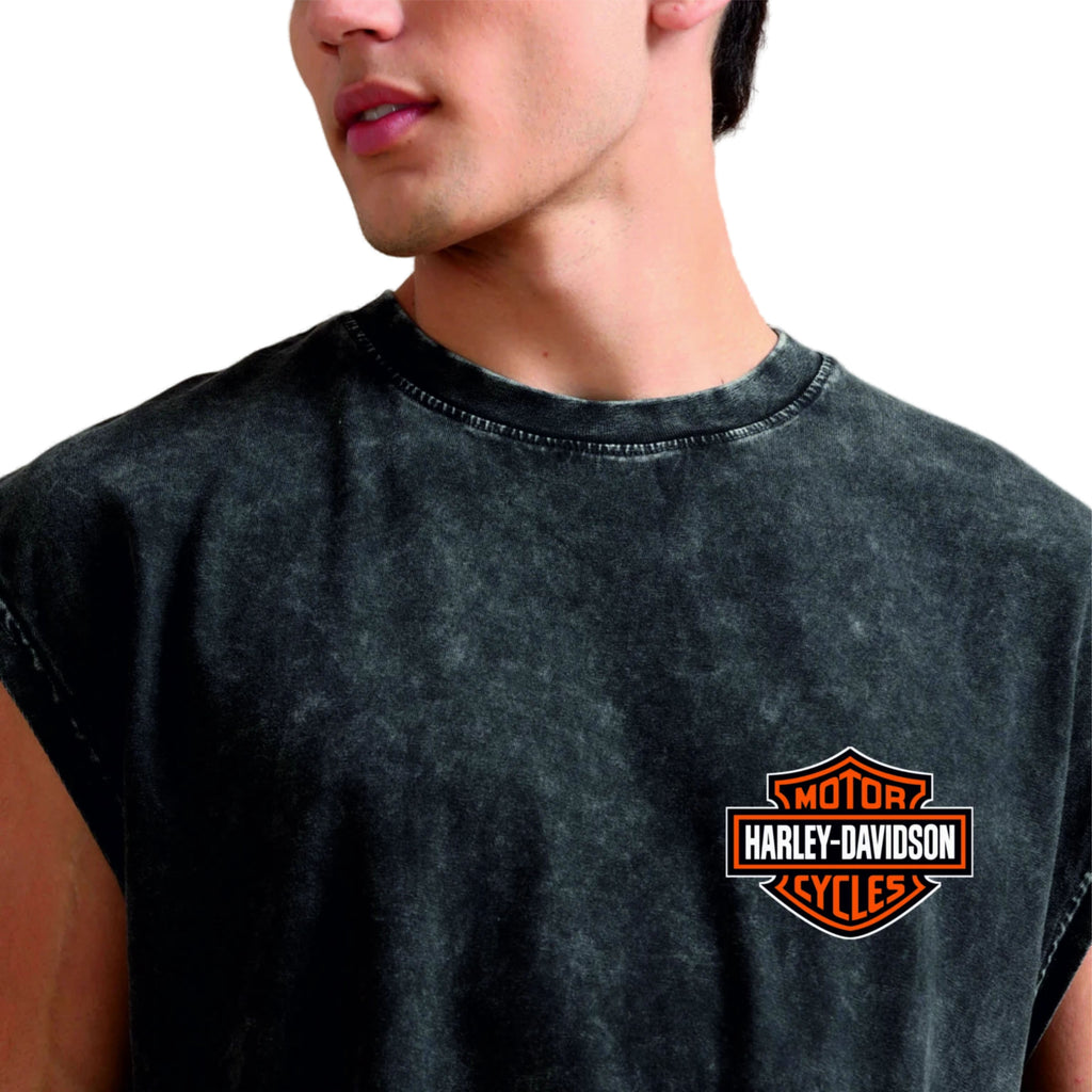 Person wearing a black sleeveless shirt with Harley-Davidson logo