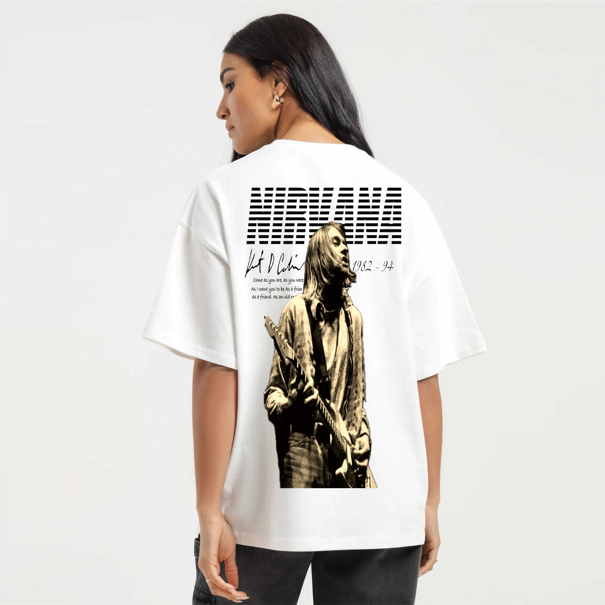 Person wearing a white t-shirt with a graphic design on the back