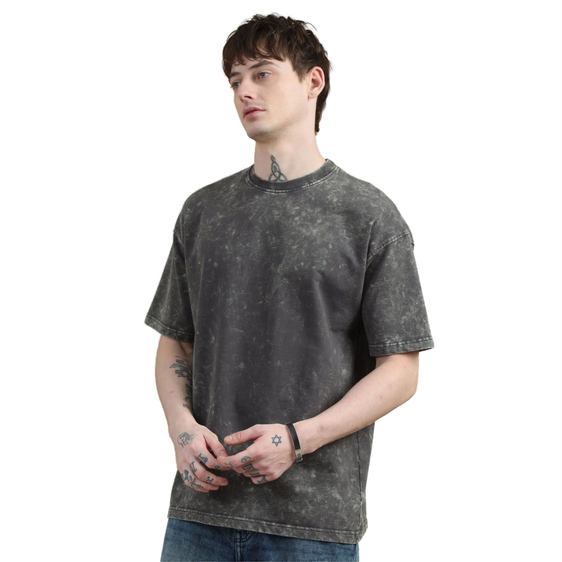 Person wearing a black acid-wash t-shirt on a white background