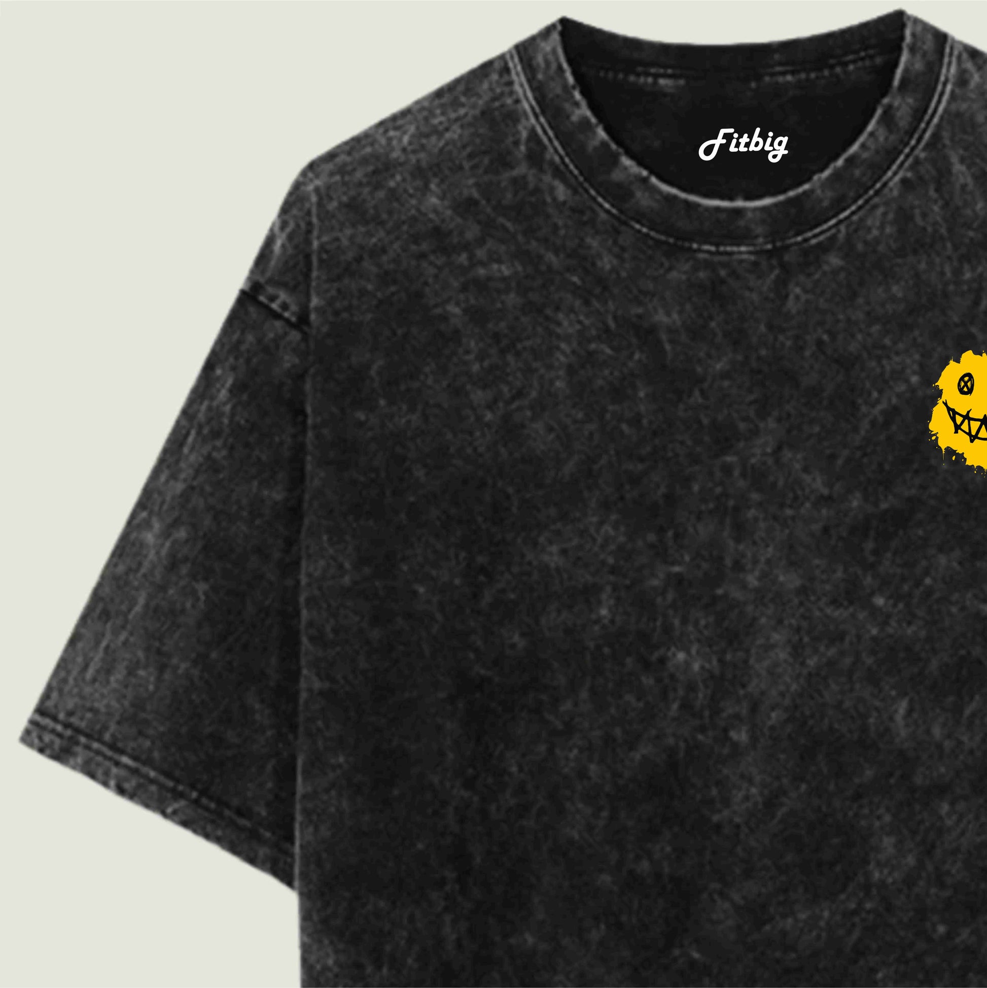Black t-shirt with a yellow logo on a light gray background