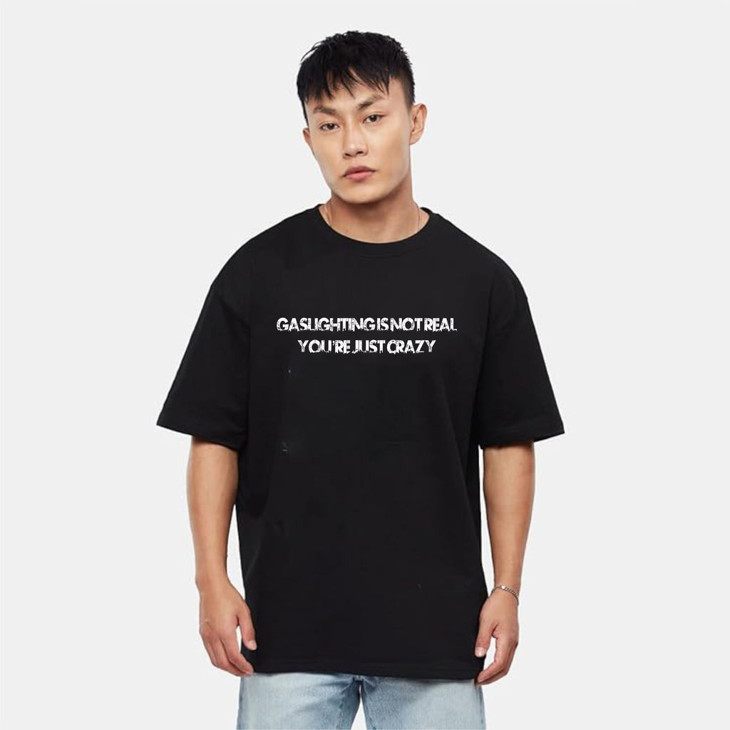 Person wearing a black t-shirt with white text on a plain background