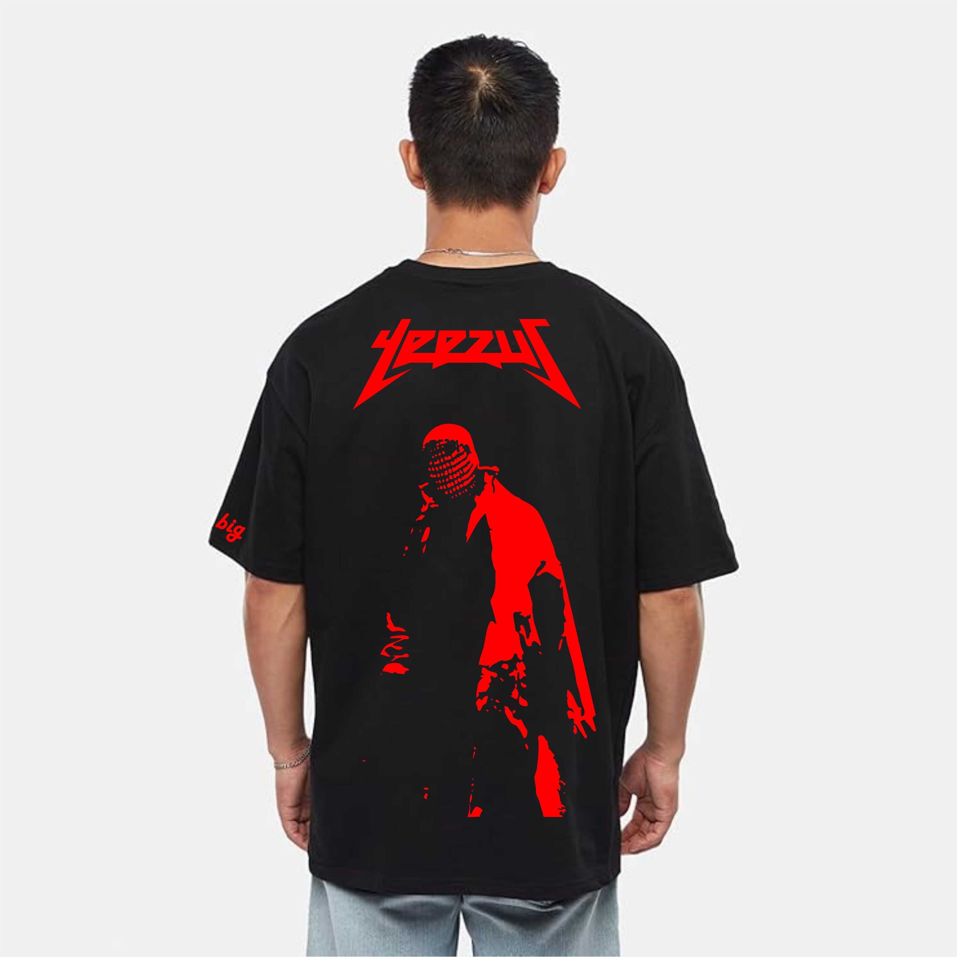 Person wearing a black t-shirt with red graphic design on the back, featuring the brand 'Zeus'.
